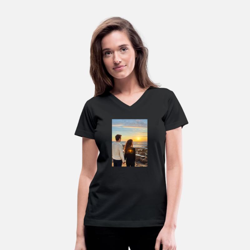 Couple Hand In Hand On Sandy Beach At Sunset